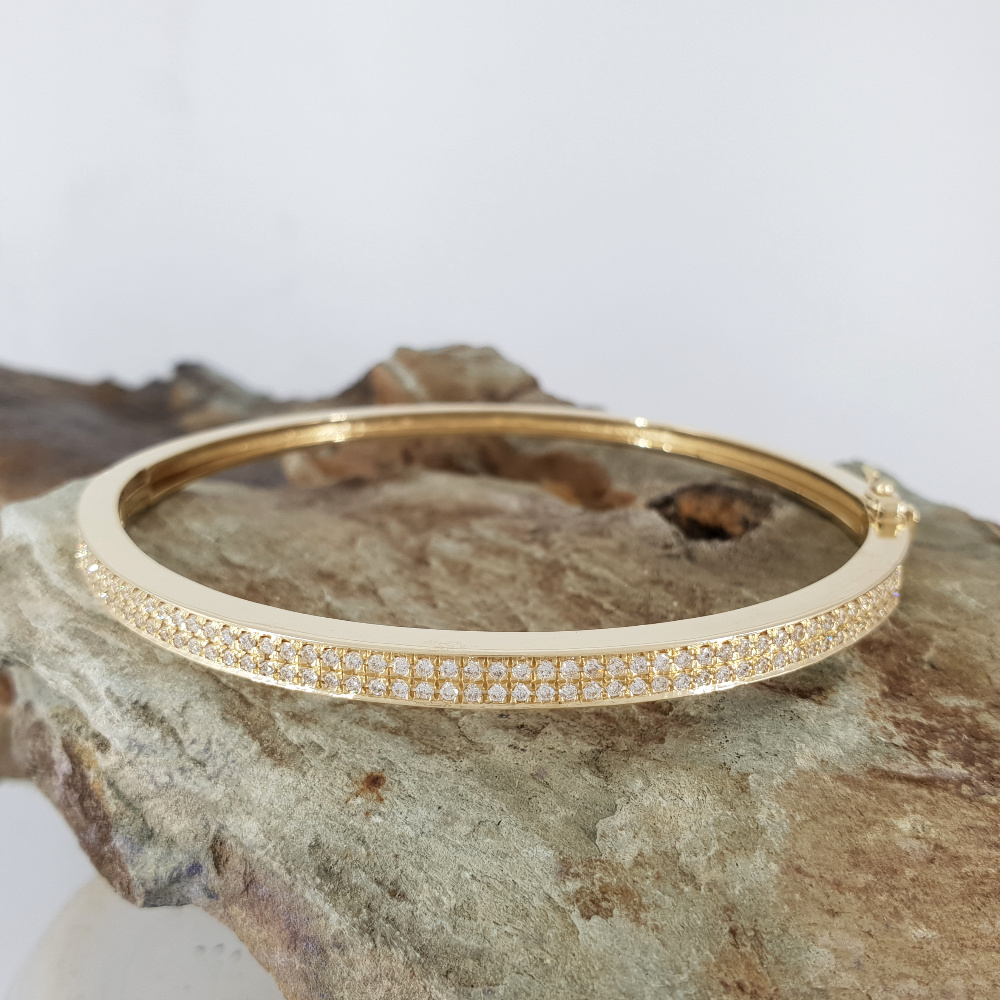 Realistic picture of A stiff bracelet -half Diamonds half Gold